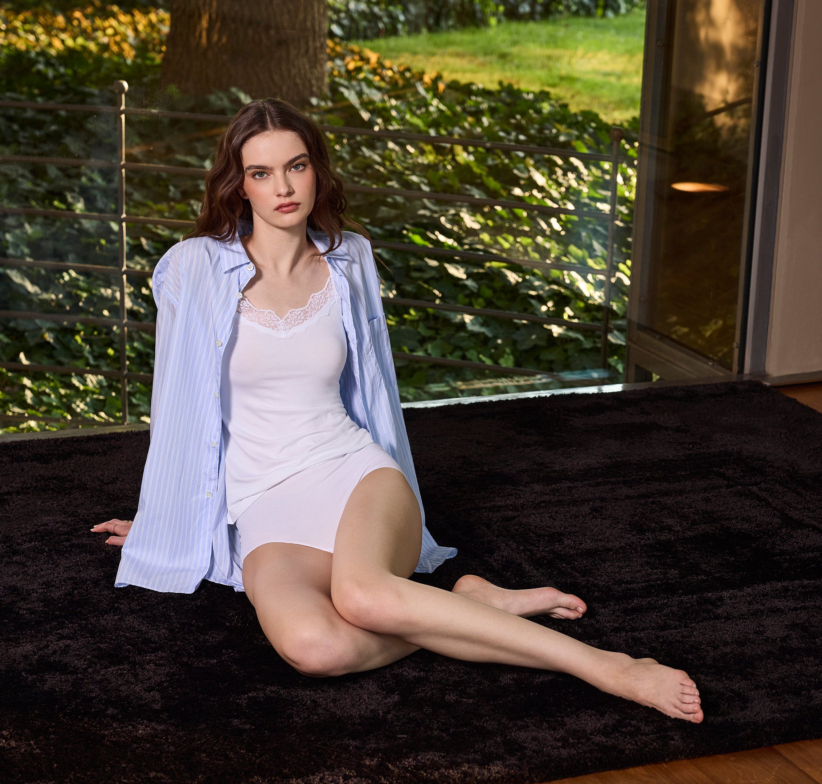 Girl wearing a viscose vest top with lace insert on the white V-neckline, white premium stretch cotton high-waisted briefs.